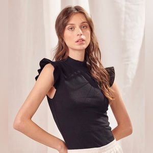 sleeveless top with mock neck and ruffled cap sleeves.